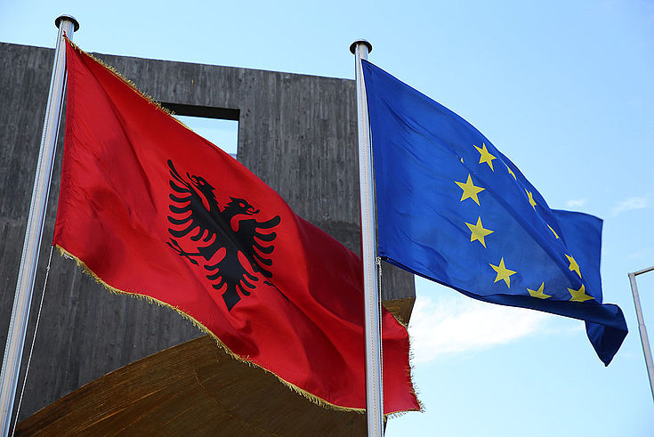 Die Flaggen Albaniens und der EU wehen nebeneinander im Wind.